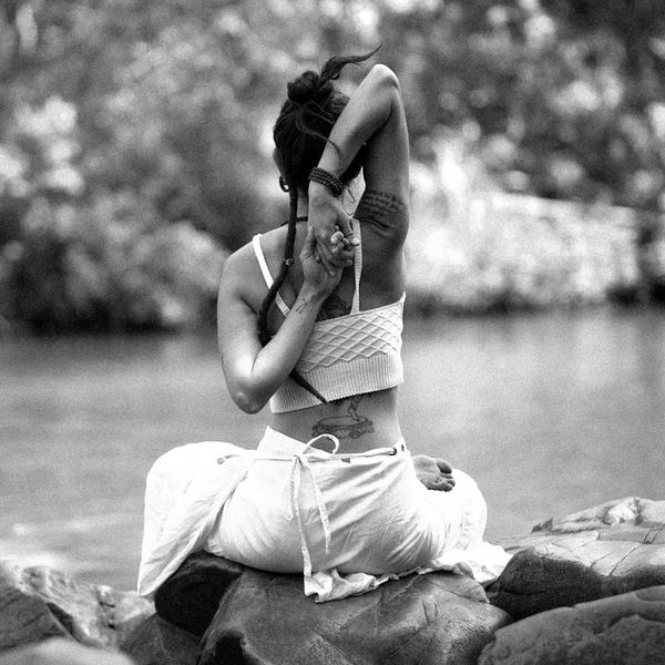 A woman in a calm, seated yoga pose, embodying peace and balance.